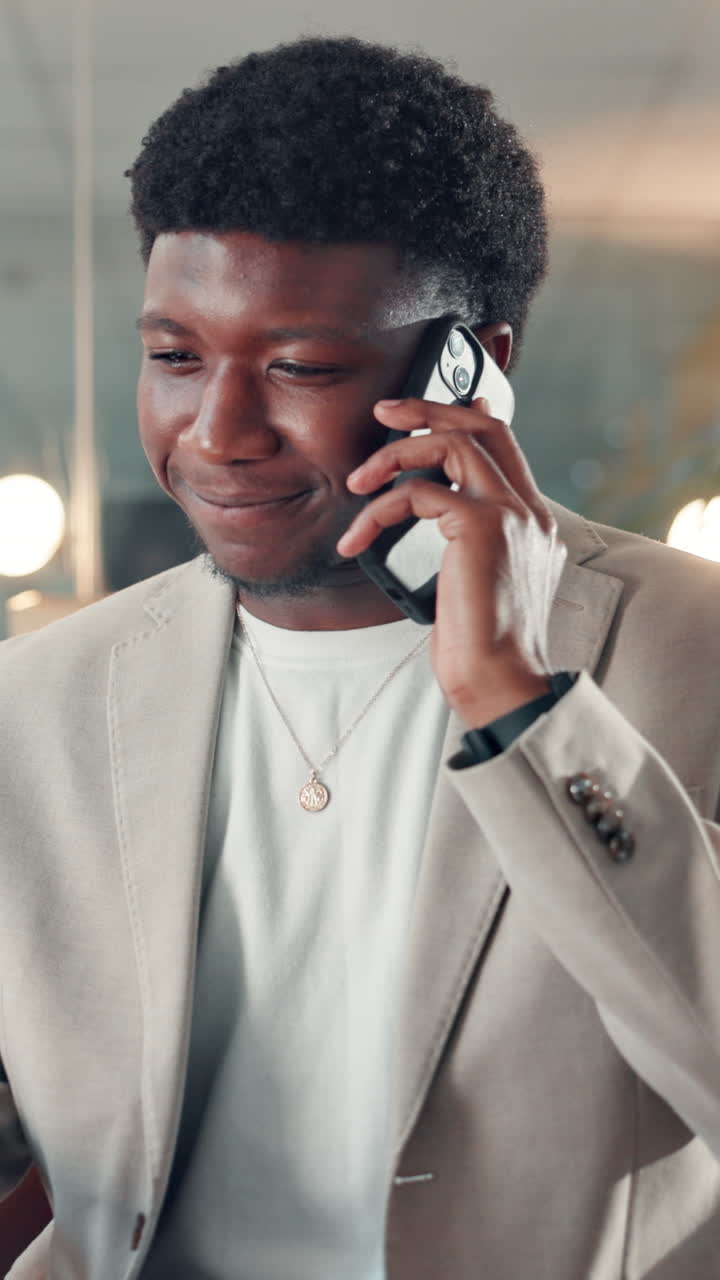 Young Black Man Talking and Smiling on Smartphone