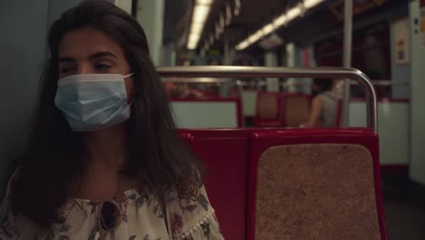 young and tired tourist wearing face mask in public transport, traveling in portugal