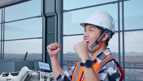 engineer celebrating success in modern industrial setting