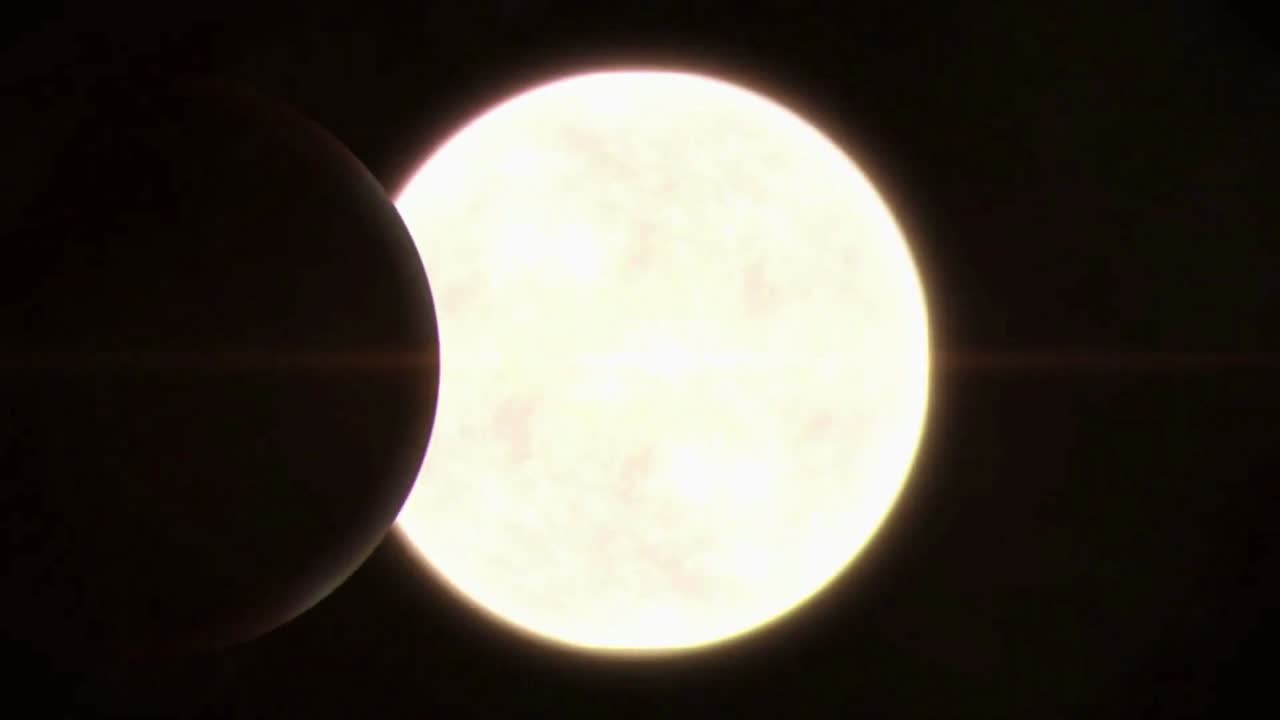 una dramática vista de cerca de un eclipse solar, mostrando la luna oscureciendo una parte del sol.