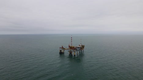 drone shot of a oil rig near the coast of ameland, the netherlands
