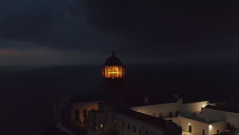 Beautiful-aerial-drone-view-of-Ponta-da-Piedade-Lighthouse-in-Lagos-Algarve,-Portugal-at-evening-dusk,-circle-pan