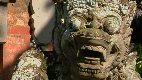 a balinese god stone carving guards a temple 1