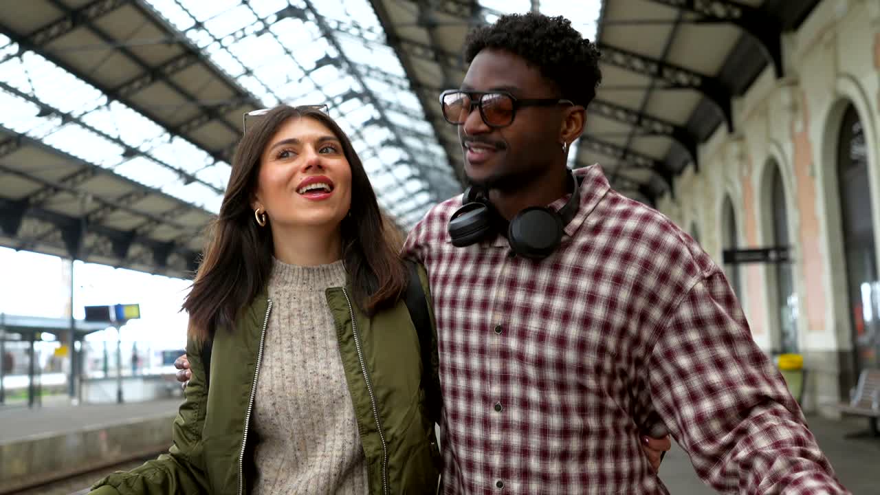 Couple traveling in train station with luggage