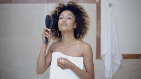 Woman-Fixing-Hair-In-The-Morning