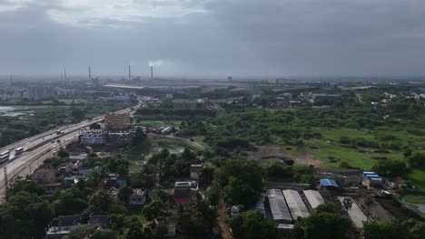 aerial view of industrial area with smokestacks and surrounding green space