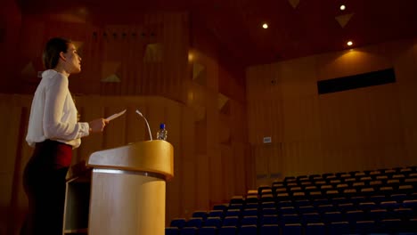 Young-Caucasian-businesswoman-practicing-speech-in-empty-auditorium-4k