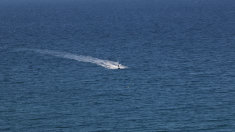 Hand-held-shot-of-jet-skis-heading-into-a-quiet-bay-off-the-coast-of-Newquay