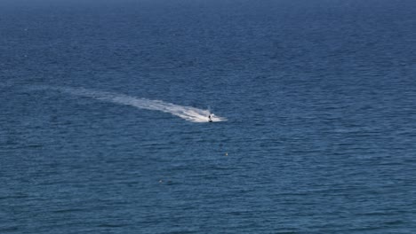 hand-held shot of jet skis heading into a quiet bay off the coast of newquay