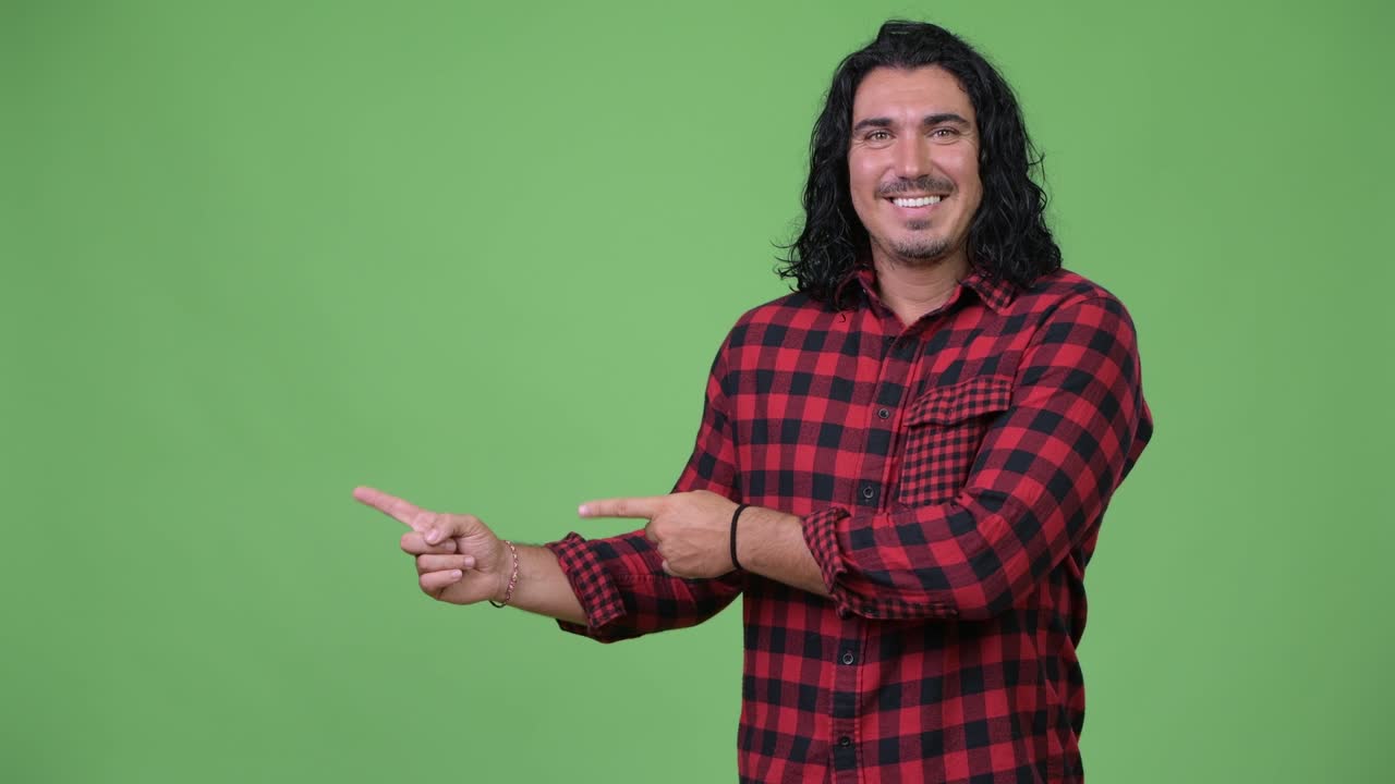 Handsome hipster man showing something