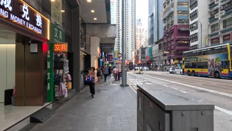 pedestrians walking along a bustling city street