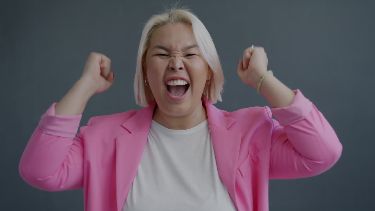 Excited Woman in Pink Blazer
