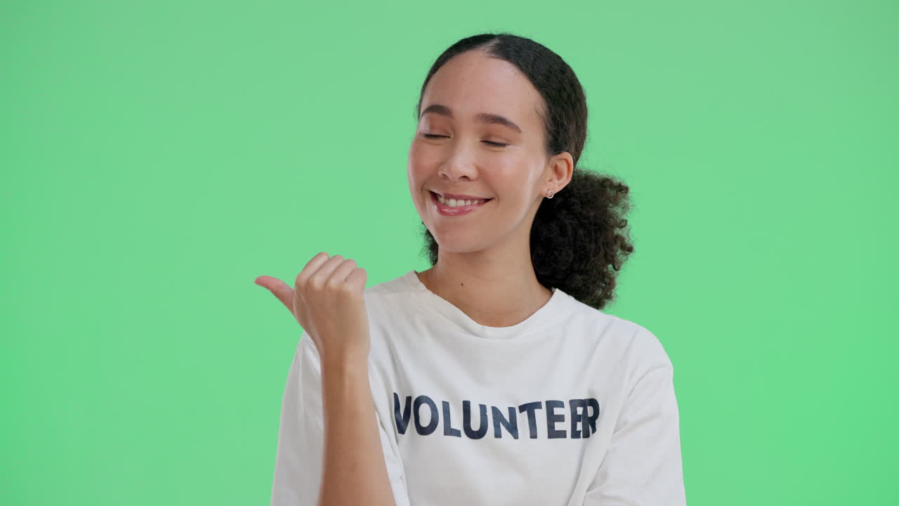 Volunteer pointing to the side on green screen