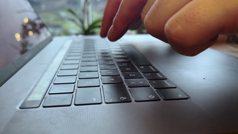 Hands-writing-on-the-keyboard-of-a-laptop