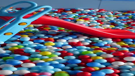 a colorful ball pit with a red slide