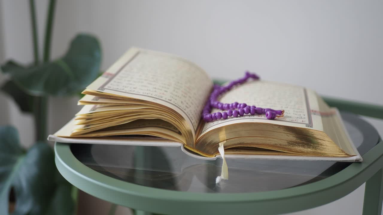 Libro sacro aperto con rosario su un tavolo