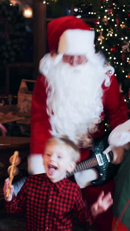 santa claus has fun, sings and dances with his children and elves in his new year's residence. vertical video