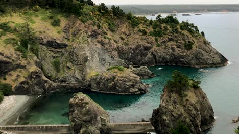 A-panning-view-of-cloud-covered-coastline,-cliffs-and-where-they-used-to-launch-Coast-Guard-boats-at-the-Port-Orford-Heads,-Oregon-in-the-Pacific-Northwest