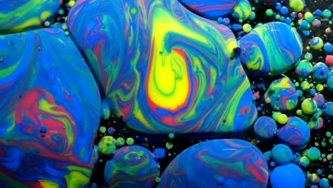 slow motion bright colors bubbles oil beautiful paint universe color moving multicolored closeup. acrylic paint. fantastic surface. abstract colorful paint metamorphosis structure colorful bubbles