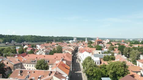 the main pedestrian street of kaunas old town with the view of church and city hall towers and vytautas the great bridge over river nemunas