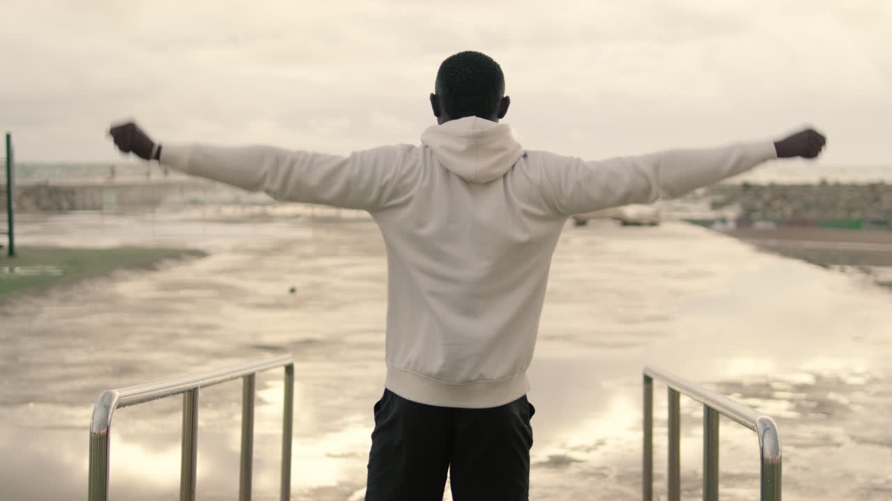 Man stretching by the beach