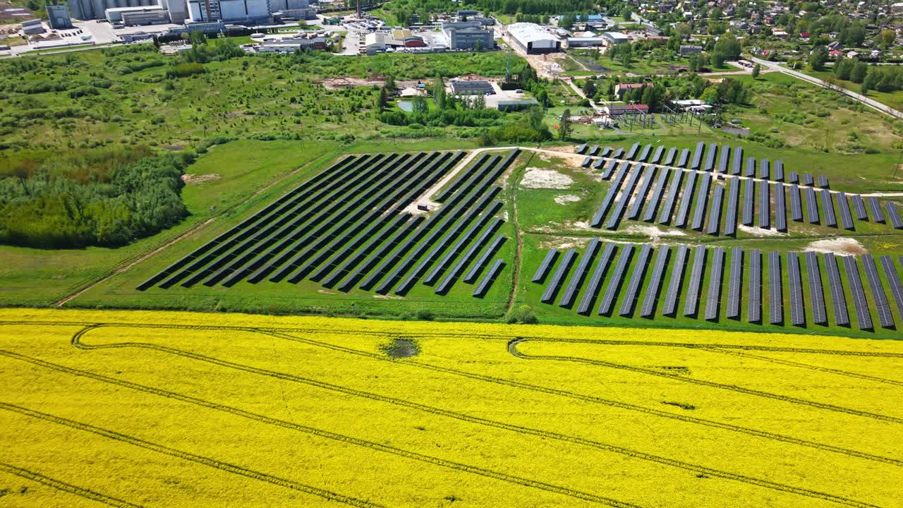 Green fields with solar panels and vibrant rapeseed crops in the background