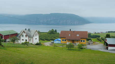 ride along the shore of the fjord from the window of a car you can see old houses and the picturesqu