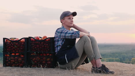 tired woman resting near boxes with tomatoes family farm harves