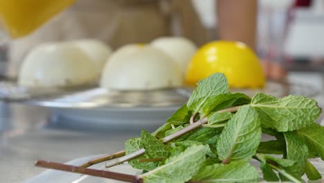 making spherical desserts with mango glaze