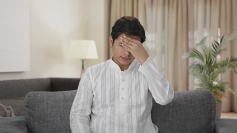 indian man taking medicine in headache