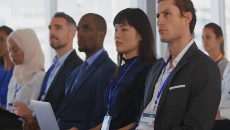 Audience-at-a-seminar-raising-hands-to-ask-questions