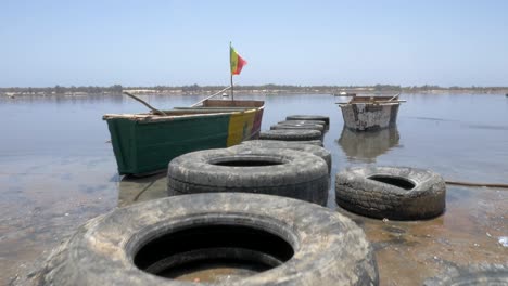 Filmische-Aufnahme-Eines-Bootes-Im-Rosafarbenen-Senegalsee-Mit-Glattem-Kran