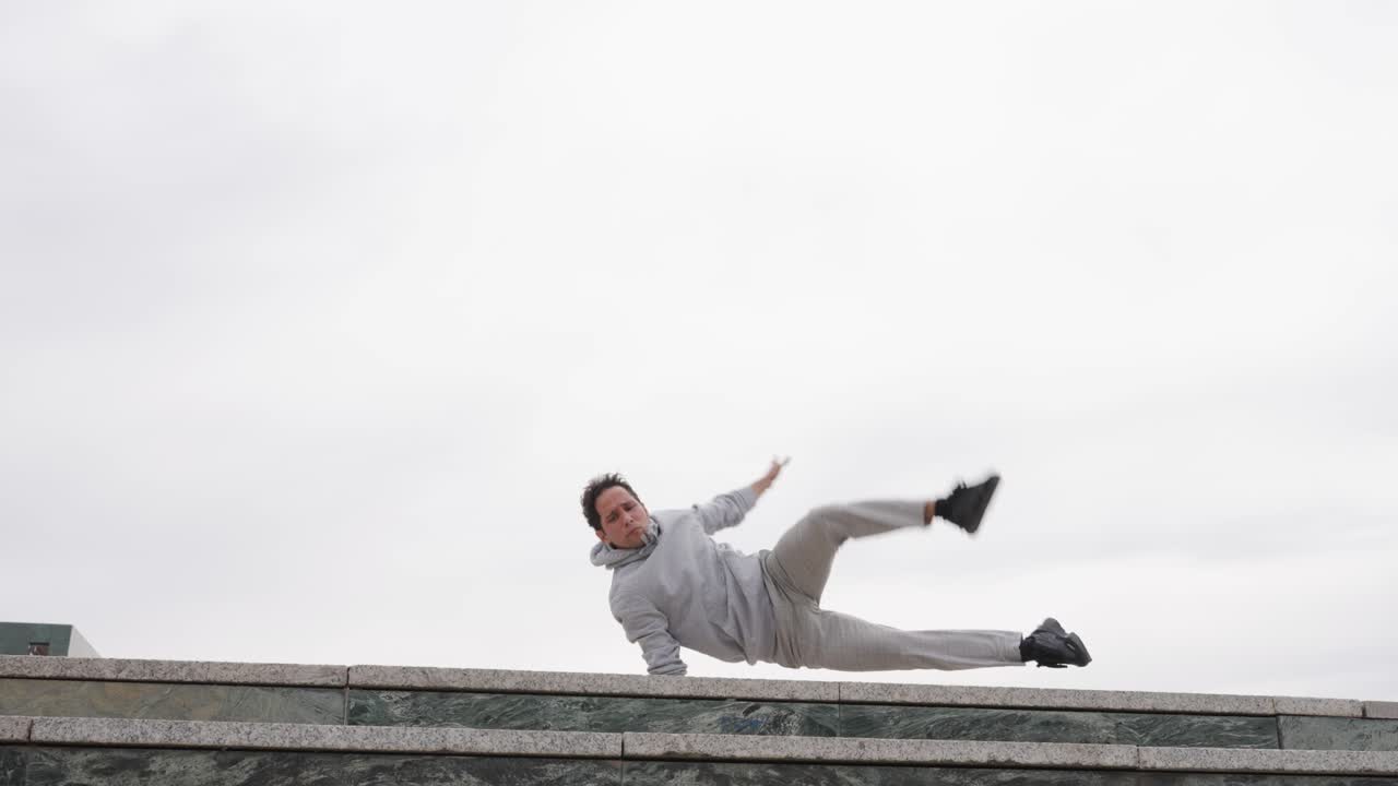 Parkour athlete performing acrobatics on building ledge