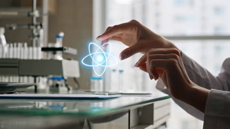 scientist holding a glowing atom symbol in a lab