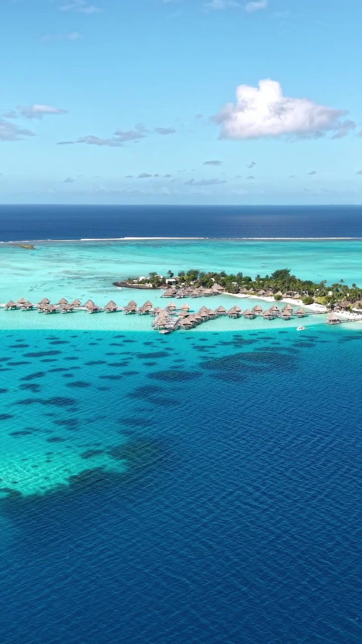 Bora Bora Island, French Polynesia. Vertical Drone View of Matira Beach, Bungalows and Turquoise Lagoon