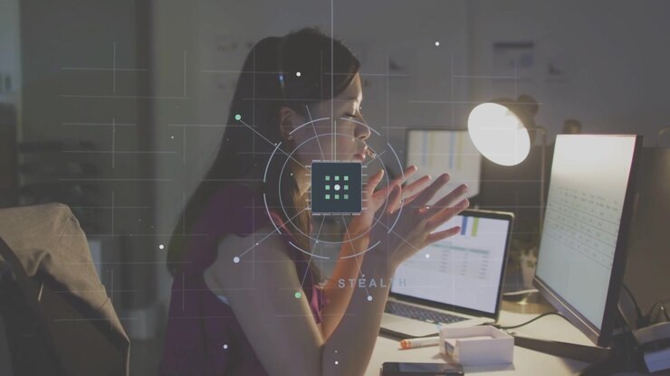 Business analyst leaning in and gesturing to monitor, initiating HUD overlay while analyzing charts