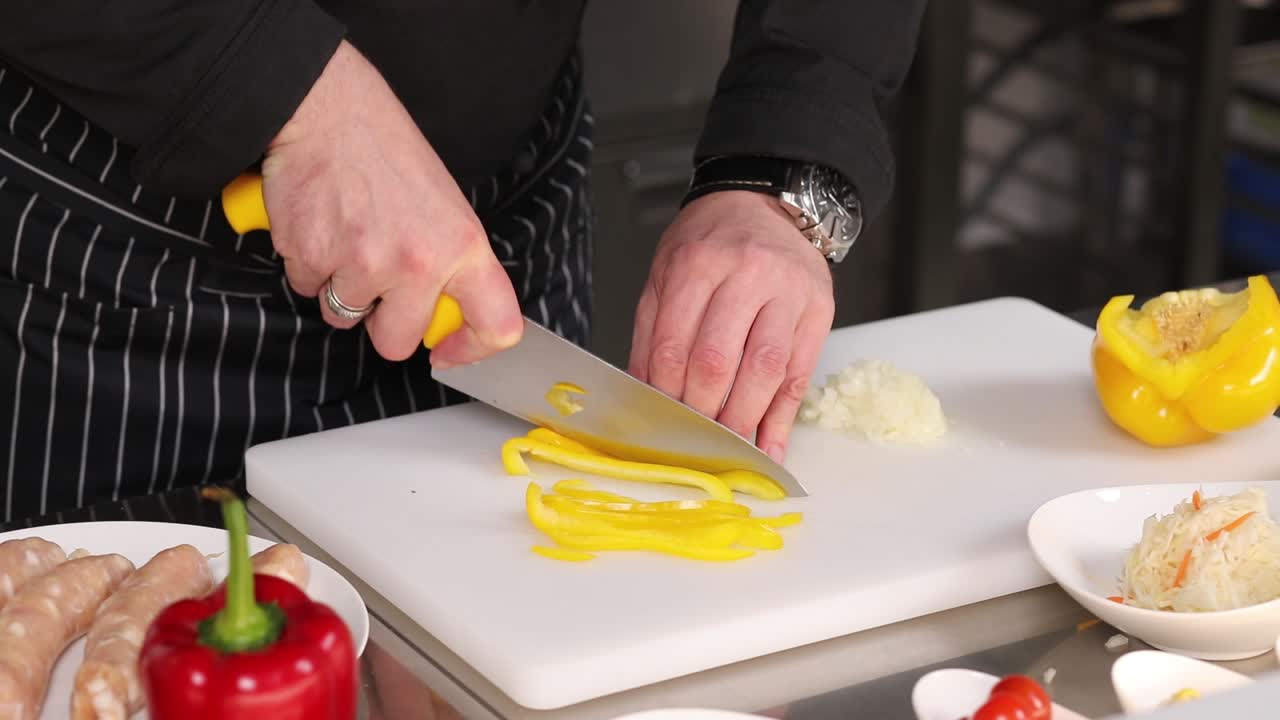 el chef cortando pimientos amarillos