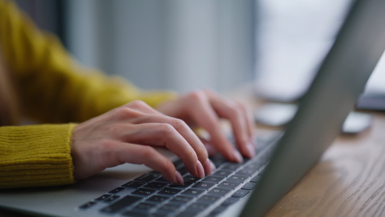 Businesswoman hands writing email on laptop at corporate office space closeup