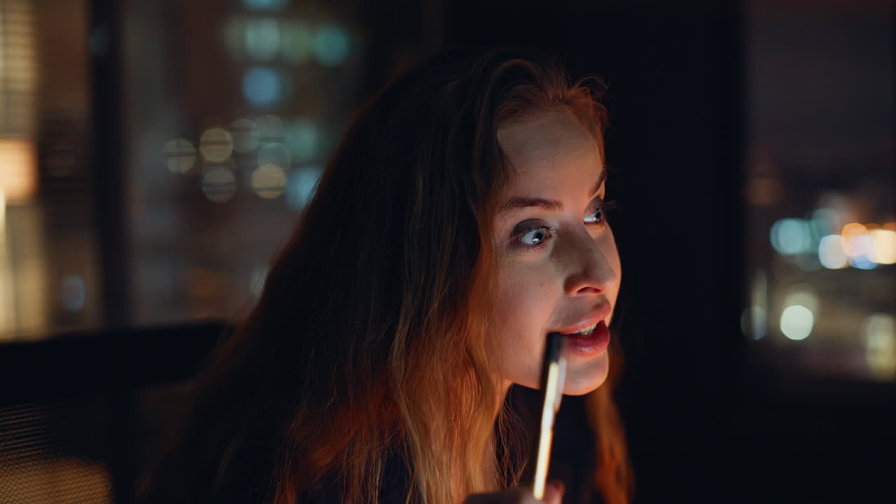 Late employee participating video interview working from dark office portrait