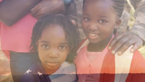 animación del paisaje sobre una feliz familia afroamericana con bandera estadounidense