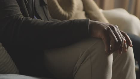 close up of nervous man about to propose to woman checking ring box in pocket