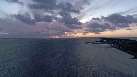 Silhouette-Of-A-Man-On-A-Kite-Board-In-The-Sea-At-Sunset,-Aerial-View