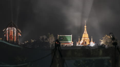 a pre-dawn time lapse of a buddhist monk walking across a suspension bridge, with a hyper zoom transition