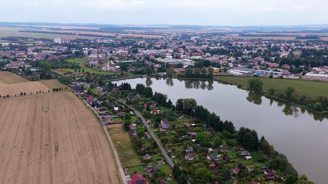 Countryside life in cottages built outside the city by a pond. Drone view of houses outside the city. Svitavy, Czech Republic