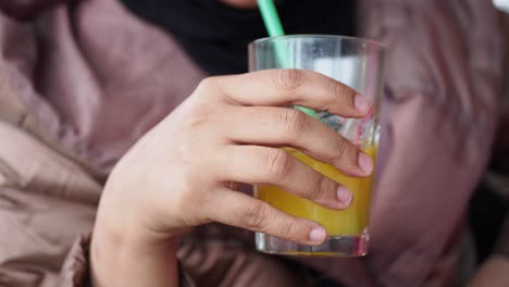 woman drinking orange juice