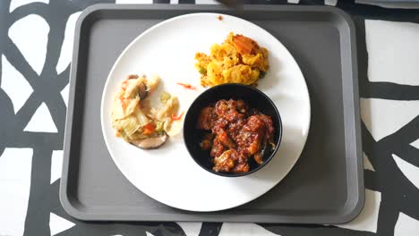 cooked red rice , vegetable salad and fish curry in a bowl on table ,