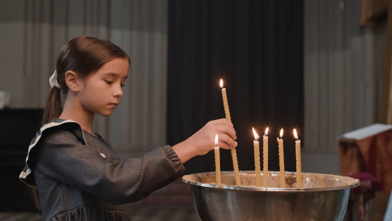 Girl Lighting Candles in Church