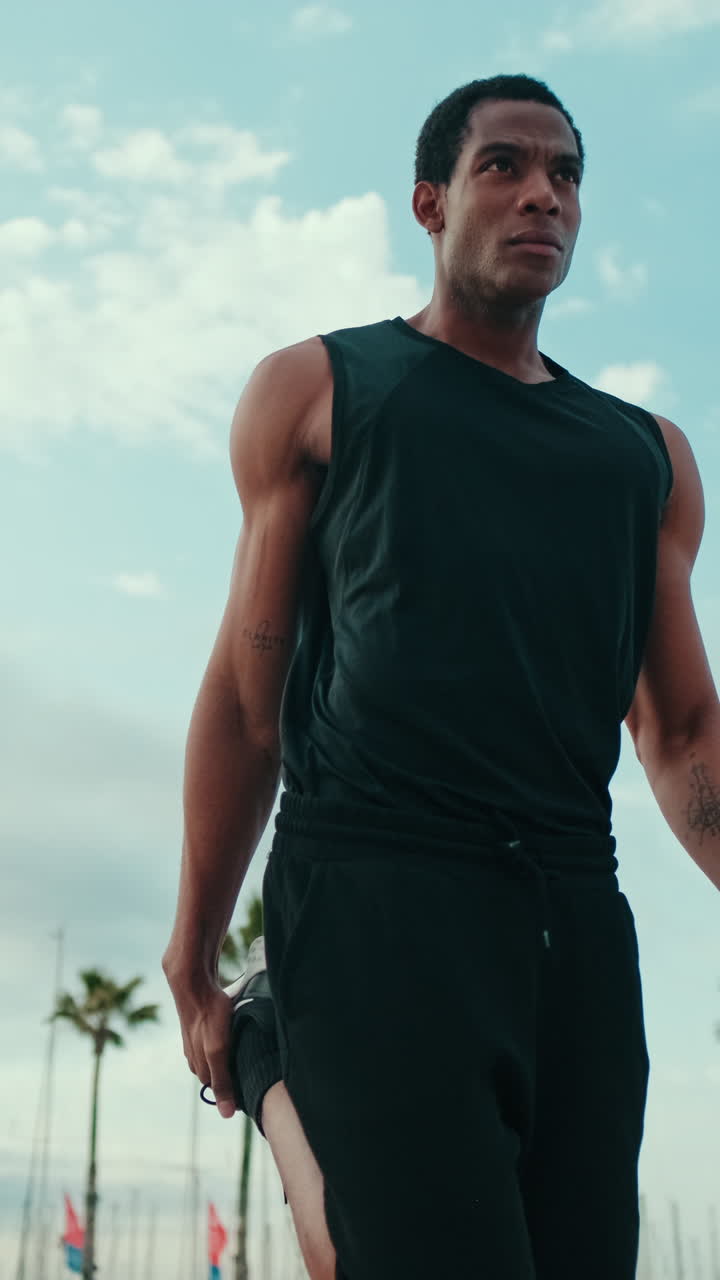 Man Stretching Before a Run on the Beach