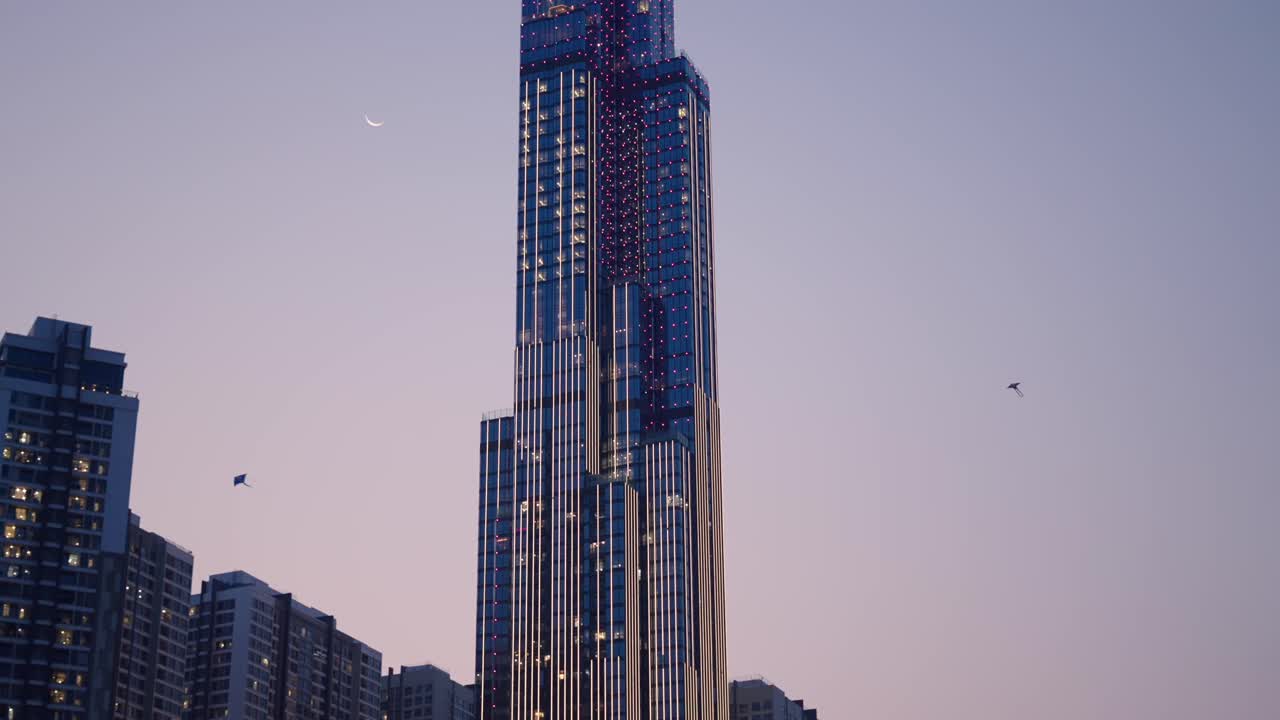 High-rise building at twilight with pink lights