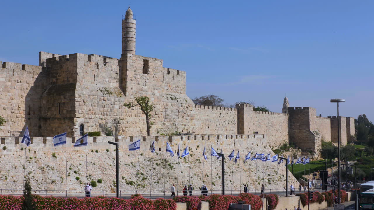 David's Citadel slow motion pan with people walking towards Jaffa Gate in Jerusalem Israel